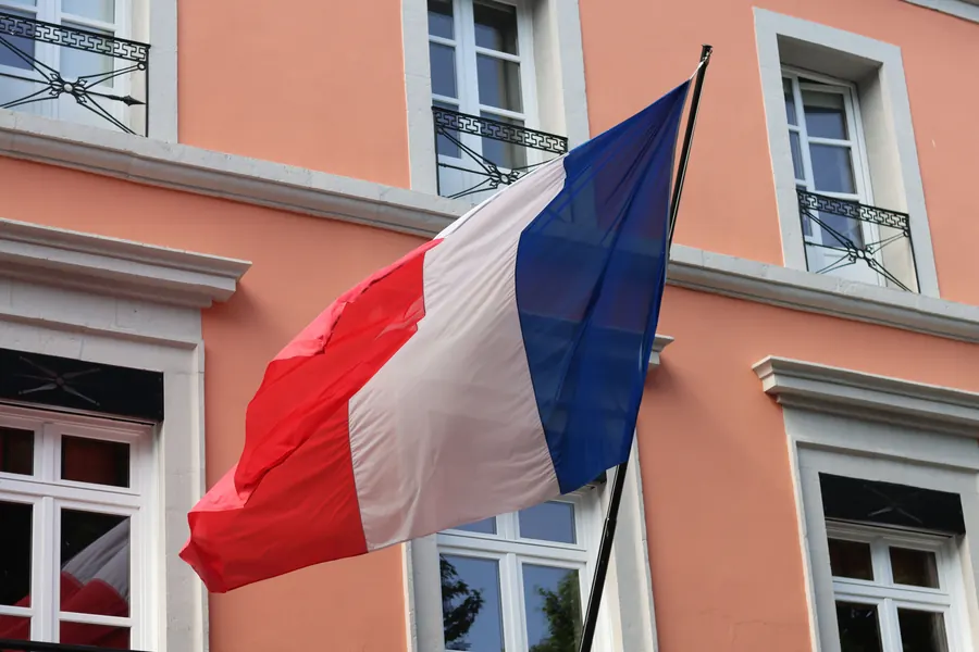 Drapeau français flottant sur la façade d’un bâtiment public
