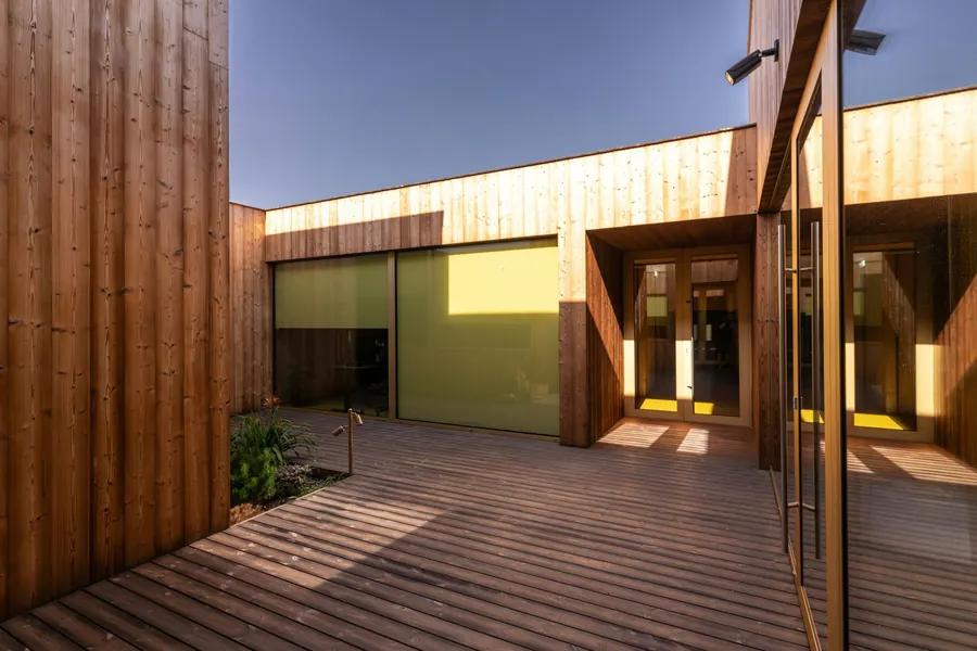 Extension d'école en bois clair, préau, cour vide