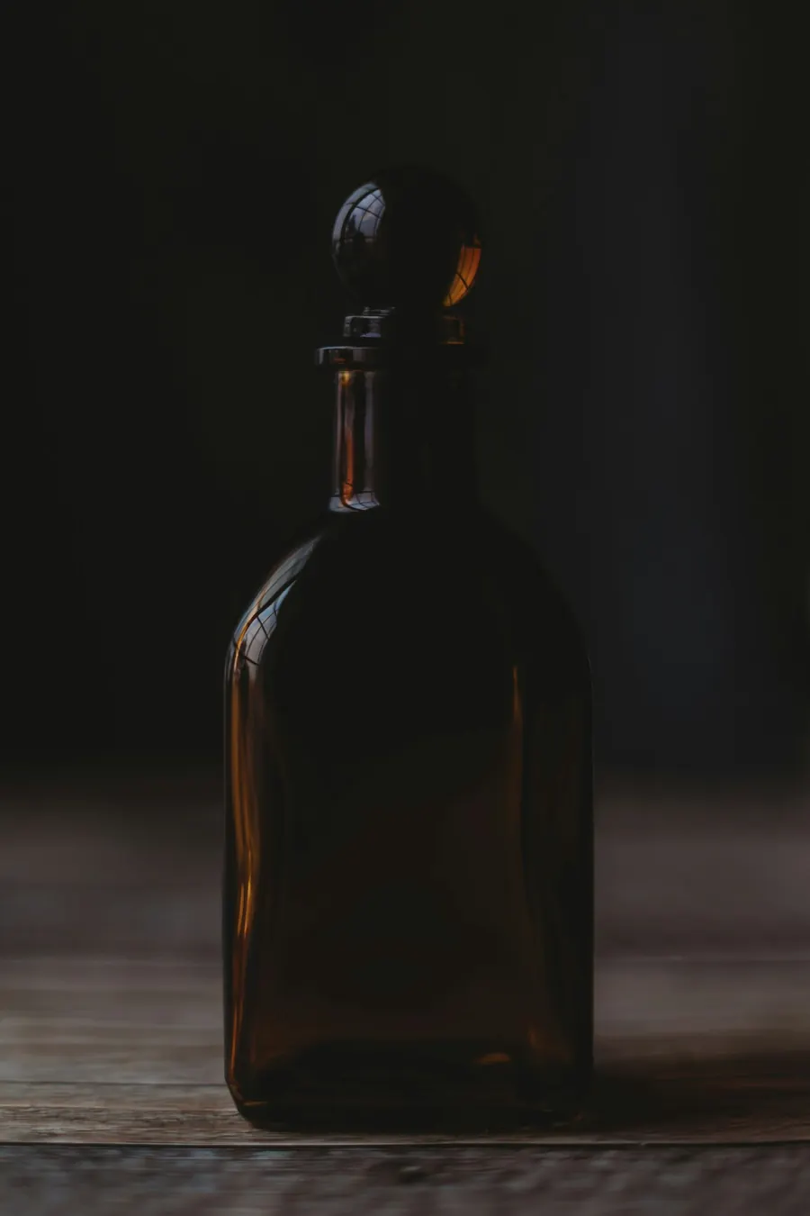 Bouteille ambrée sans étiquette sur fond sombre