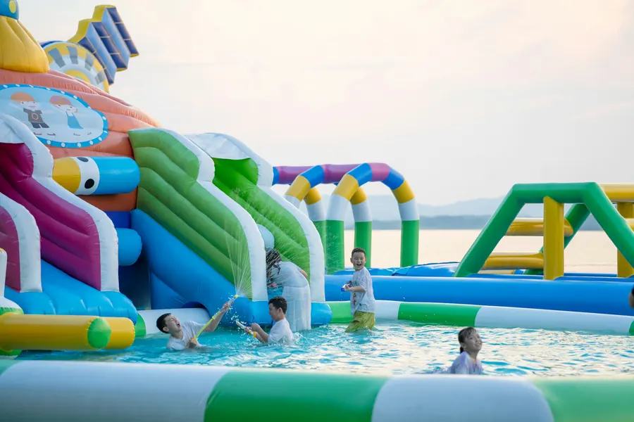 Enfants qui jouent sur des structures gonflables colorées d'un parc aquatique