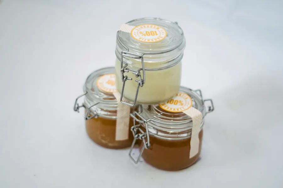 Trois petits bocaux à fermeture métallique remplis de confiture ambrée