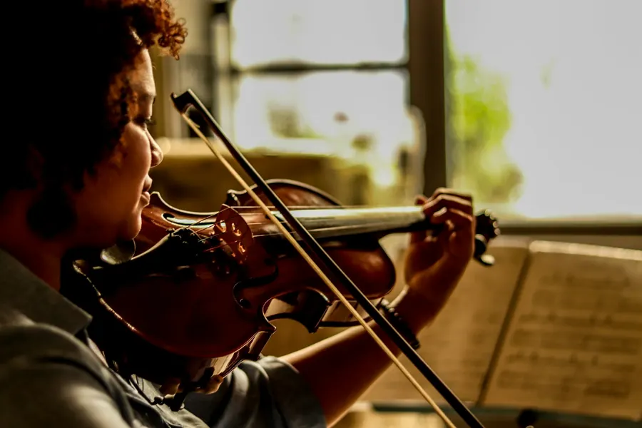 Jeune violoniste qui joue seul face à une partition