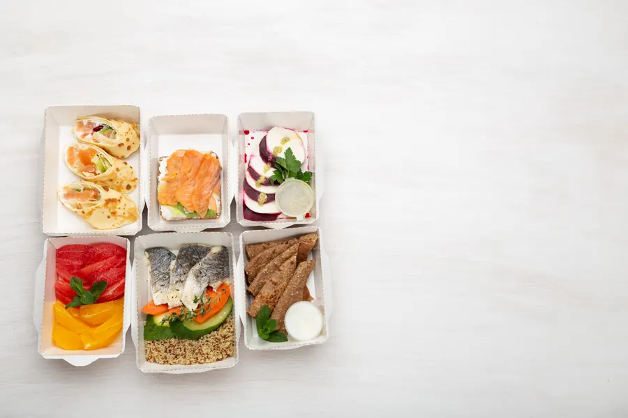 Plateau-repas : entrée, poisson, fromage, dessert, pain, sur un bureau